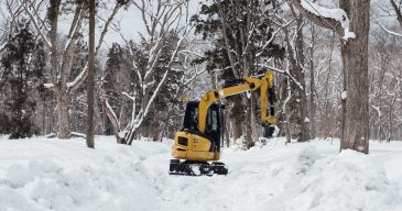 backhoe in snow at togakushi shrine, Japan