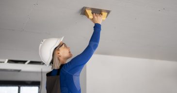 medium-shot-smiley-woman-fixing-roof